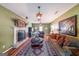 Comfortable living room with a fireplace, hardwood floors, and stylish furnishings at 12 Blackfoot Trl, Sharpsburg, GA 30277