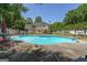 Large in-ground pool with an organic shape and well-maintained concrete surround at 12 Blackfoot Trl, Sharpsburg, GA 30277