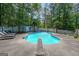 Private backyard oasis with a pristine pool and plenty of space for sunbathing at 12 Blackfoot Trl, Sharpsburg, GA 30277