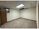 Unfinished basement room with carpeting, drop ceiling, and window; waiting for customization at 4081 Jodeco Rd, Stockbridge, GA 30281