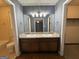Bathroom featuring double sink vanity, illuminated mirror, and neutral wall color at 4081 Jodeco Rd, Stockbridge, GA 30281