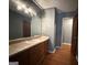 Bathroom showcasing a marble countertop vanity with a large mirror and vanity lighting at 4081 Jodeco Rd, Stockbridge, GA 30281