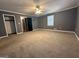 Large, neutral bedroom features plush carpeting, closet and a view to an adjoining room at 4081 Jodeco Rd, Stockbridge, GA 30281