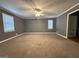 Spacious bedroom with carpet, and two windows allowing plenty of natural light at 4081 Jodeco Rd, Stockbridge, GA 30281