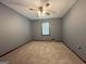 Cozy bedroom with neutral carpet, ceiling fan, and window letting in natural light at 4081 Jodeco Rd, Stockbridge, GA 30281