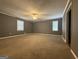 Spacious carpeted bedroom bathed in natural light with neutral paint color and ceiling fan at 4081 Jodeco Rd, Stockbridge, GA 30281