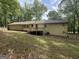 Rear exterior of the home featuring a deck and sprawling backyard at 4081 Jodeco Rd, Stockbridge, GA 30281