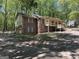 Exterior view of the property with brick, siding, mature trees and two car garage at 4081 Jodeco Rd, Stockbridge, GA 30281