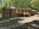 Traditional brick and siding home with a covered front porch and mature trees at 4081 Jodeco Rd, Stockbridge, GA 30281