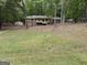 A charming two-story home with a covered porch, set back from the street with a grassy front yard at 4081 Jodeco Rd, Stockbridge, GA 30281