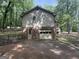 View of the side and rear of the house showcasing the garage and backyard at 4081 Jodeco Rd, Stockbridge, GA 30281