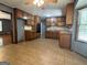 Spacious kitchen featuring ample counter space, tile floors, wooden cabinets, and modern appliances at 4081 Jodeco Rd, Stockbridge, GA 30281