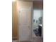 A full bathroom with a white toilet, gray mat, dark cabinets, and light walls at 6153 Oakley Rd, Union City, GA 30291