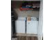 Convenient laundry area features a washer, dryer, and built-in shelving for efficient storage at 6153 Oakley Rd, Union City, GA 30291