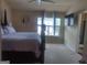 A well-lit room with a ceiling fan and a cozy bed at 6153 Oakley Rd, Union City, GA 30291