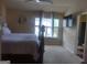 A well-lit room with a ceiling fan and a cozy bed at 6153 Oakley Rd, Union City, GA 30291