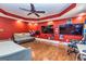 Spacious bedroom with hardwood floors, ceiling fan, large windows, and lounge area with gray couch at 26 Cannongate Rd, Sharpsburg, GA 30277