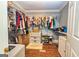 Walk-in closet featuring custom shelving, ample storage space, and hardwood floors at 26 Cannongate Rd, Sharpsburg, GA 30277