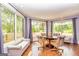 Sun-drenched dining area showcasing hardwood floors, large windows, and seating at 26 Cannongate Rd, Sharpsburg, GA 30277