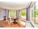 Bright dining room features hardwood floors, large windows, and a round table with seating for four at 26 Cannongate Rd, Sharpsburg, GA 30277