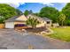 Well-maintained home features a garage, palm trees, and nice landscaping at 26 Cannongate Rd, Sharpsburg, GA 30277