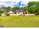 Spacious home featuring a well-manicured lawn and mature trees at 26 Cannongate Rd, Sharpsburg, GA 30277