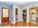 Open hallway view showcasing beautiful wood floors and access to multiple rooms at 26 Cannongate Rd, Sharpsburg, GA 30277