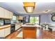 Charming kitchen with white cabinets, lots of counter space, and a dining area at 26 Cannongate Rd, Sharpsburg, GA 30277