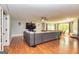 Spacious living room with a large couch, natural lighting, and a ceiling fan at 26 Cannongate Rd, Sharpsburg, GA 30277