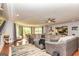 Spacious living room featuring a large sectional sofa, area rug, and abundant natural light at 26 Cannongate Rd, Sharpsburg, GA 30277