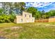 The two-story outbuilding features a simple design with a few windows and a door at 26 Cannongate Rd, Sharpsburg, GA 30277