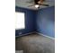 Bedroom features bright blue walls and carpet at 4616 Hamlet Se Walk, Conyers, GA 30094
