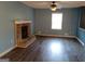 Cozy living room with a brick fireplace, ceiling fan, and hardwood floors at 4616 Hamlet Se Walk, Conyers, GA 30094