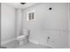 Compact bathroom featuring gray tile flooring and a standard toilet at 1620 Saddle Ridge Way, Sandy Springs, GA 30350