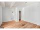Spacious bedroom featuring hardwood floors and white walls, with doorways leading to other rooms at 1620 Saddle Ridge Way, Sandy Springs, GA 30350