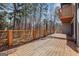 A spacious wooden deck with a horizontal railing offers stunning views of the surrounding lush greenery at 1620 Saddle Ridge Way, Sandy Springs, GA 30350