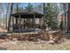 A backyard gazebo with a stone retaining wall at 1620 Saddle Ridge Way, Sandy Springs, GA 30350
