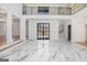 Spacious living room with marble floors, high ceilings, and a view of the balcony at 1620 Saddle Ridge Way, Sandy Springs, GA 30350