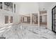 Open-concept living space with marble floors, high ceilings, and access to a covered outdoor area at 1620 Saddle Ridge Way, Sandy Springs, GA 30350