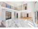 Expansive living area with a balcony, marble floors, and a view of the surrounding landscape at 1620 Saddle Ridge Way, Sandy Springs, GA 30350