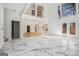 Bright and spacious living room with marble floors and a vaulted ceiling, leading to an outdoor deck at 1620 Saddle Ridge Way, Sandy Springs, GA 30350