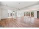 Bright living room with hardwood floors, white walls, and glass doors opening to the outdoors at 1620 Saddle Ridge Way, Sandy Springs, GA 30350
