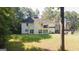 The home's backyard offers green grass and treelined views at 1231 Hillview Rd, Hampton, GA 30228