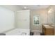 Bathroom featuring a window, a tub with shower and a vanity with sink at 1231 Hillview Rd, Hampton, GA 30228