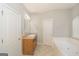 Well-lit bathroom with a large vanity, cabinets and a separate tub at 1231 Hillview Rd, Hampton, GA 30228