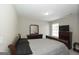 This bedroom features neutral walls, a wooden sleigh bed, and a coordinating dresser with mirror at 1231 Hillview Rd, Hampton, GA 30228