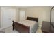 Bedroom featuring a wooden sleigh bed with dresser and a view of the closets at 1231 Hillview Rd, Hampton, GA 30228