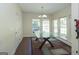 Bright dining area featuring a glass table, modern chandelier, and lots of natural light from several large windows at 1231 Hillview Rd, Hampton, GA 30228