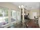 Bright dining area featuring a glass table and lots of natural light from several large windows overlooking the backyard at 1231 Hillview Rd, Hampton, GA 30228