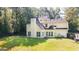 Backyard view of home with an abundance of windows, a large yard, and mature trees at 1231 Hillview Rd, Hampton, GA 30228